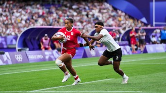 Keyara Wardley runs with the rugby ball