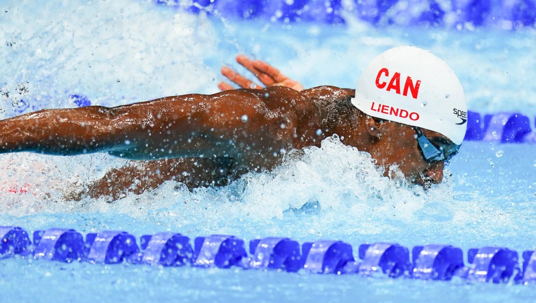 Joshua Liendo swims butterfly stroke in a white cap