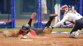 Canada's Joey Lye, left, is tagged by United States' Aubree Munro at home plate during the softball game between the United States and Canada at the 2020 Summer Olympics.