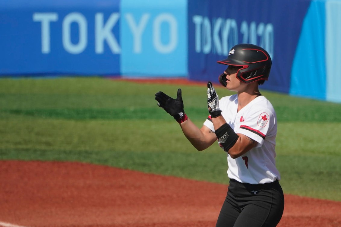 Canada's Jenn Salling celebrates a single in the second inning of a softball game against Japan in Yokohama Baseball Stadium, at the 2020 Summer Olympics, Sunday, July 25, 2021, in Yokohama, Japan.