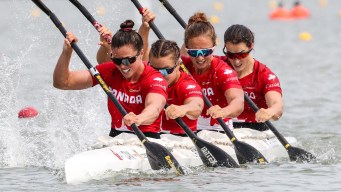 Crew of four women kayakers racing