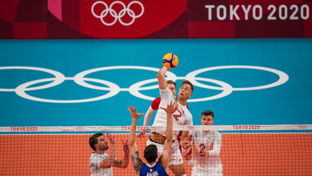 Canada middle blocker Lucas van Berkel #12 spikes the ball as Italy middle blocker Simone Anzani #17 attempts to block during the menís preliminary round at Ariake Arena during the Tokyo 2020 Olympic Games on Saturday,July 24, 2021. Photo by Leah Hennel/COC
