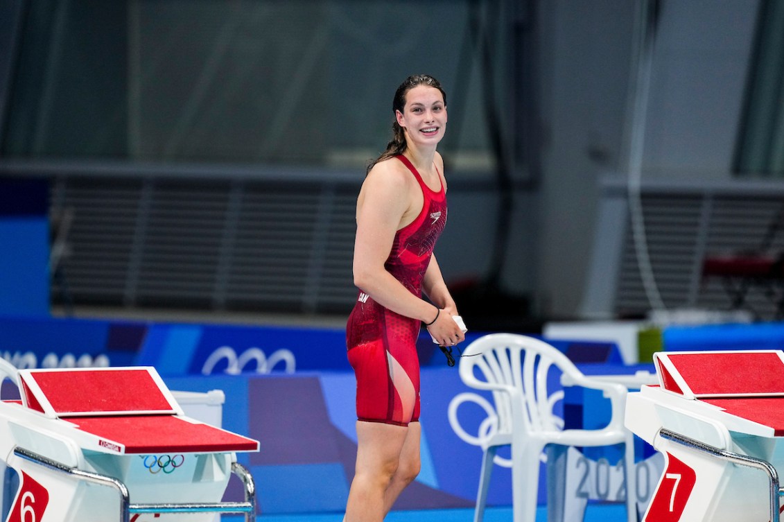 Penny Oleksiak smiles on the pool deck