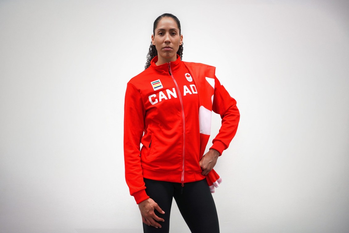 Miranda Ayim poses with Canadian flag draped over shoulder