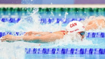 Maggie MacNeil swimming the 100m butterfly