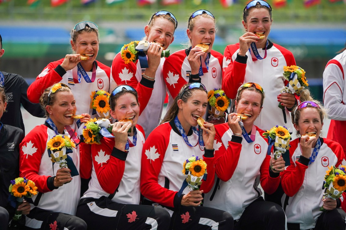 Team Canada women's eight crew take a photo with gold medals