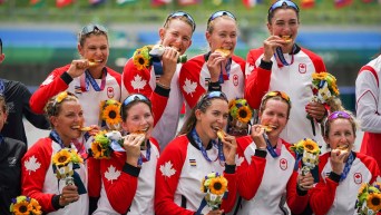 Team Canada women's eight crew bite their medals