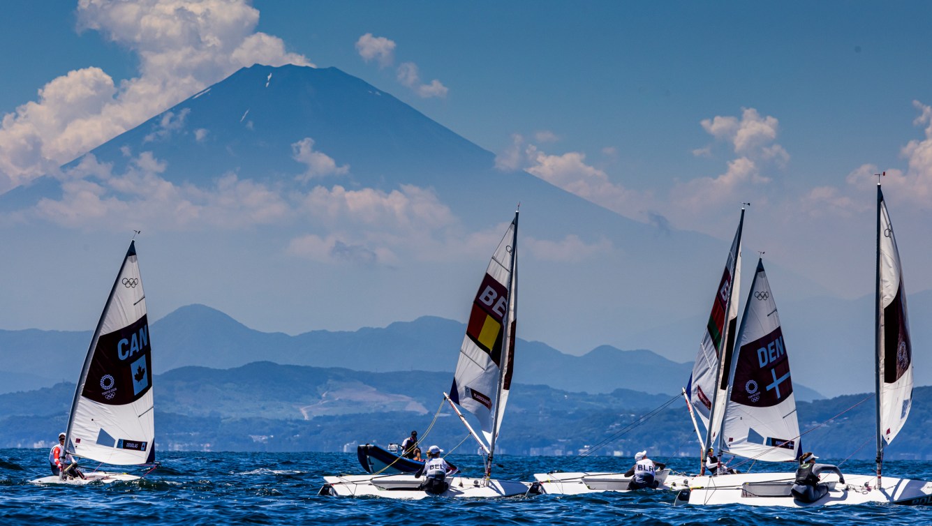 Wide shot of sailboats in front of Mount Fuji