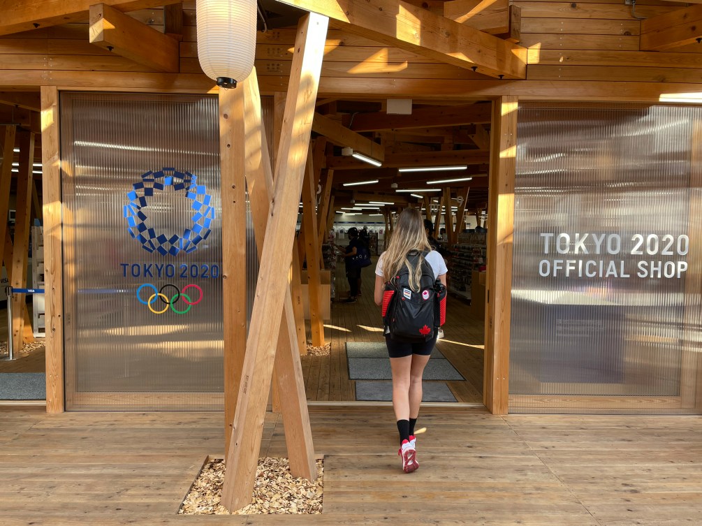 Store front of the Tokyo 2020 official shop made of wood larch with the Tokyo logo on the front window