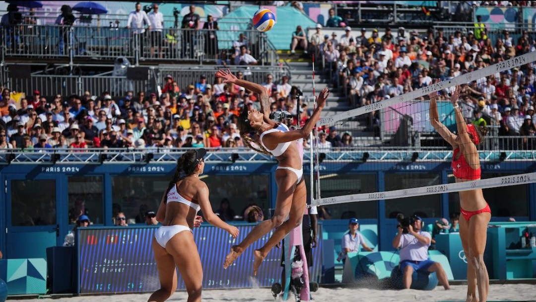 Brandie Wilkerson jumps into the air to smash the ball