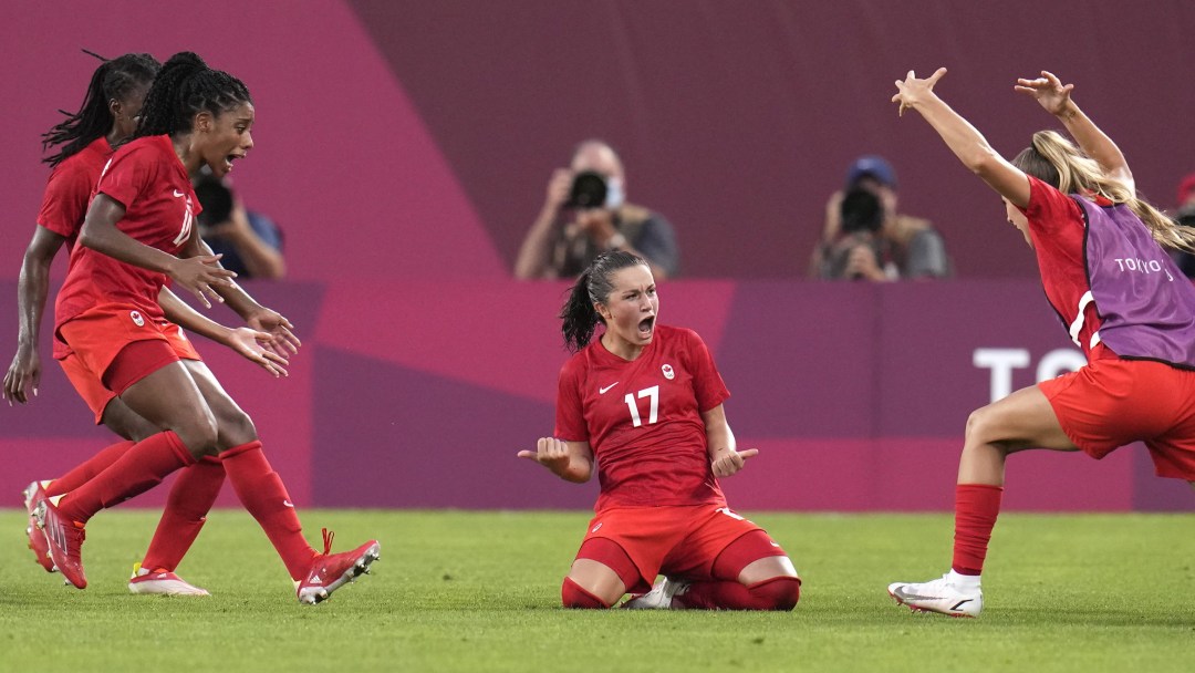 Jessie Fleming celebrates with teammates