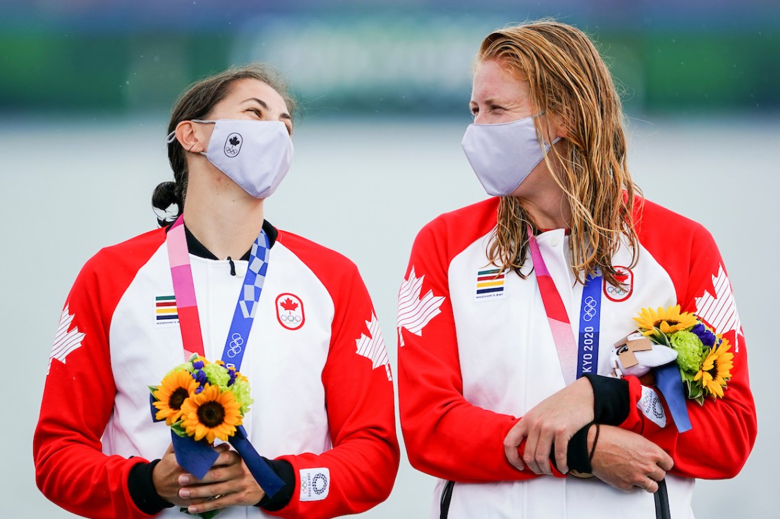 Laurence Vincent Lapointe and Katie Vincent smile at each other on the podium