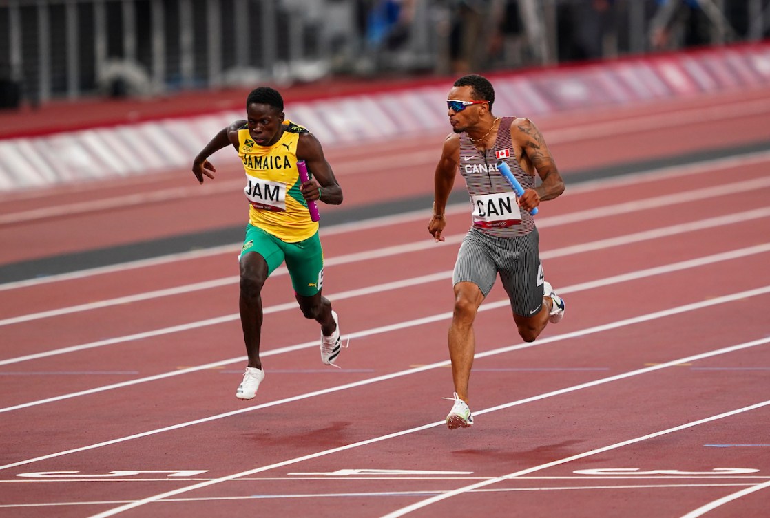 Andre De Grasse looks over the finish line in the men's 4x100 metre relay.