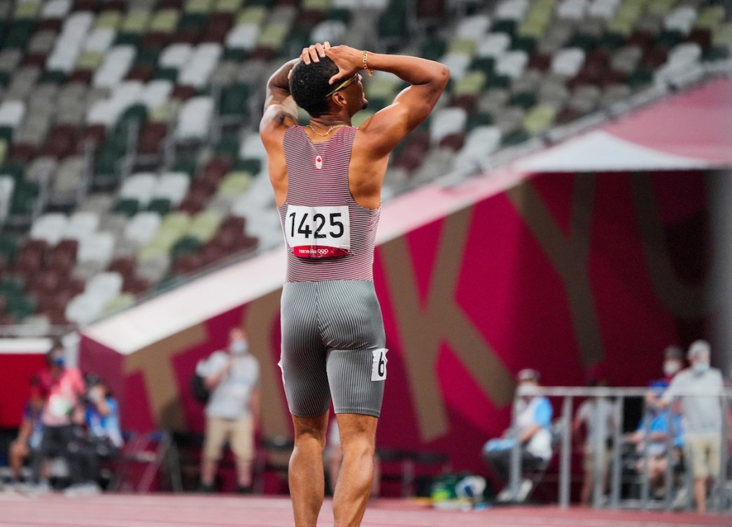 Andre De Grasse looks up at the scoreboard after 200-metre final