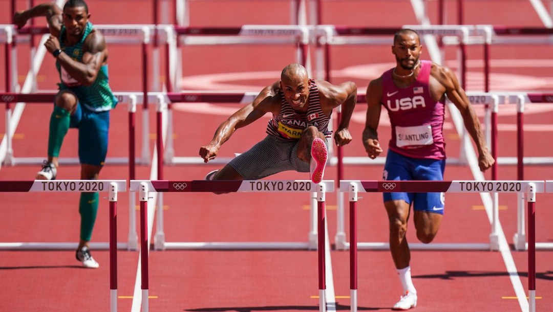 Damian Warner races over the 110-metre hurdles in the decathlon.