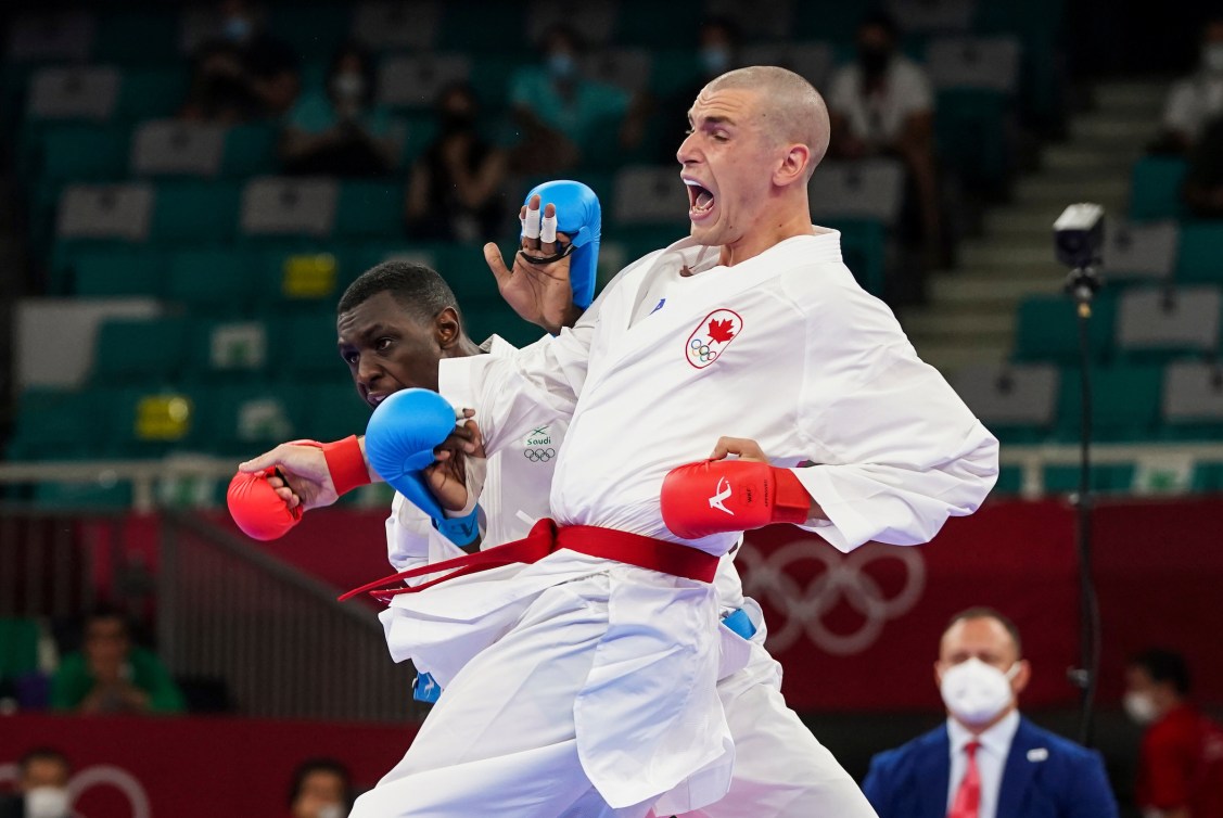 Daniel Gaysinsky makes a punch in karate 