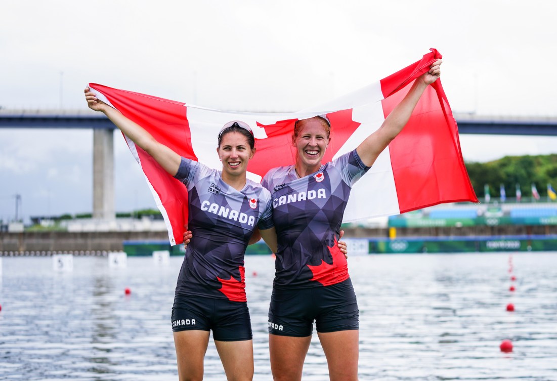 Laurence Vincent Lapointe and Katie Vincent pose with the Canadian flag 