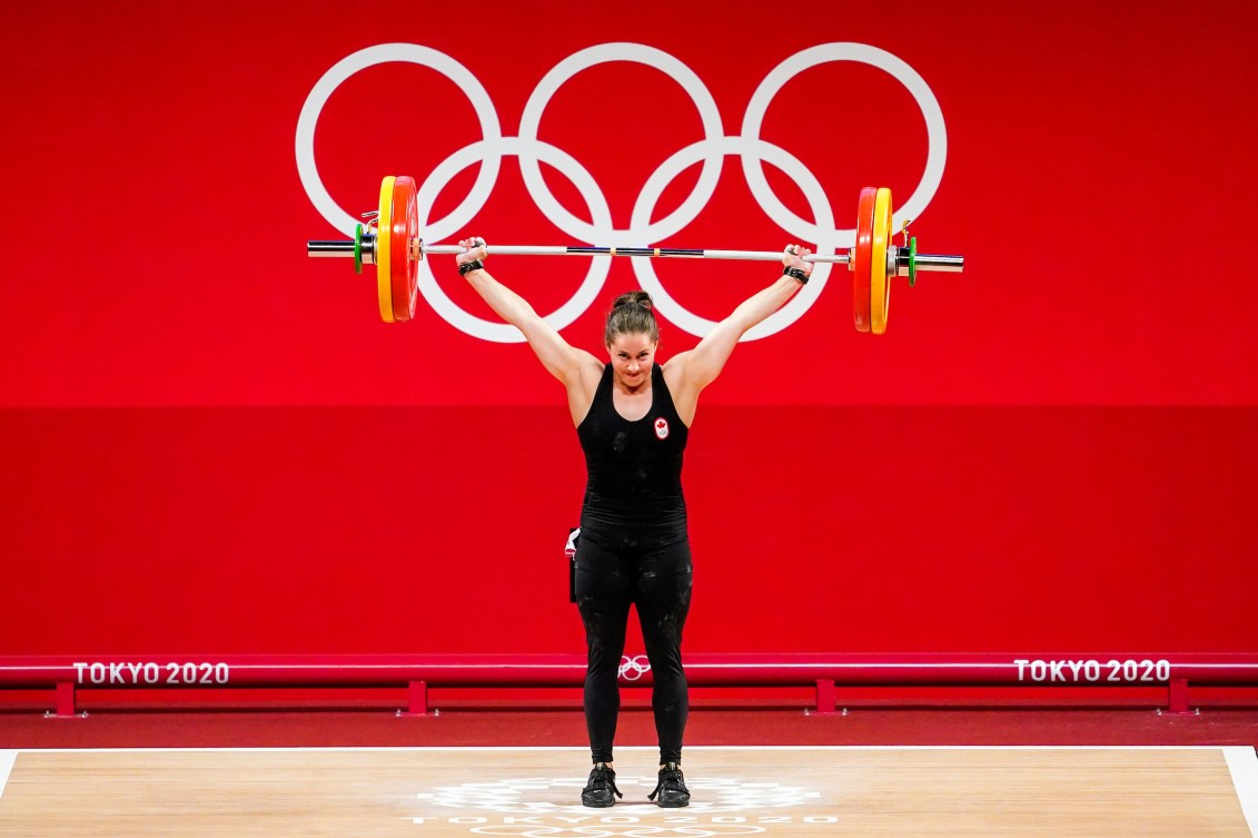 Maude Charron lifts barbell above head