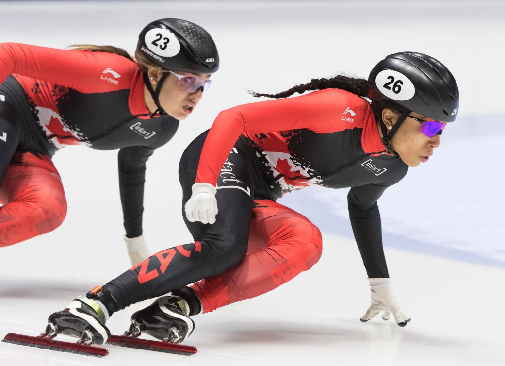 Alyson Charles and Courtney Sarault go around a turn in a short track race 