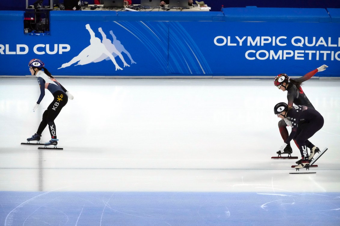 Lee Yu-bin of South Korea, left, crosses the finish line in first place as Kristen Santos of the United States, bottom right, and Courtney Sarault of Canada compete during the final of the women's 1500m at the ISU World Cup Short Track speed skating competition, a test event for the 2022 Winter Olympics, at the Capital Indoor Stadium in Beijing, Saturday, Oct. 23, 2021. (AP Photo/Mark Schiefelbein)