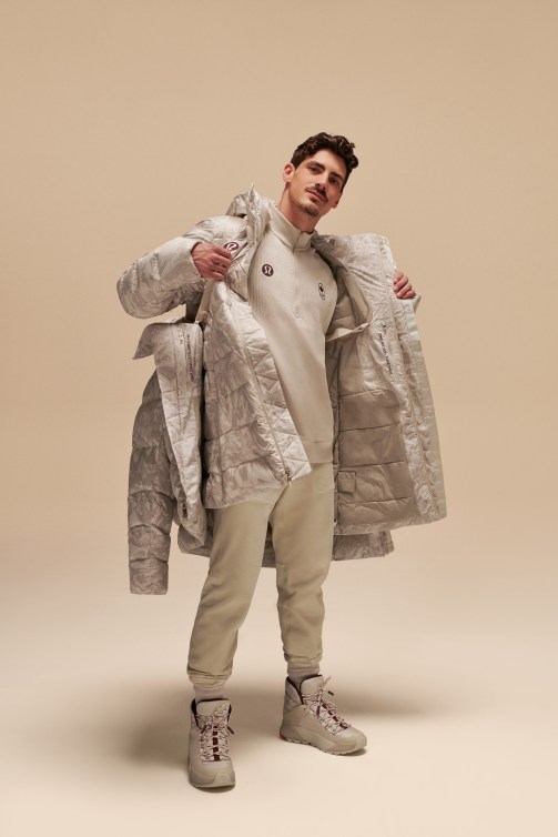 Paul Poirier poses in a white jacket and pants