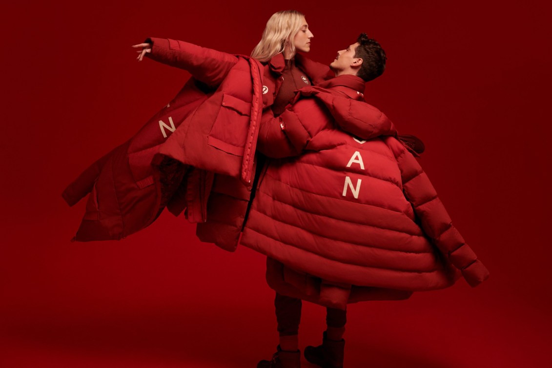 Piper Gilles and Paul Poirier perform a dance lift while wearing the red opening ceremony uniform