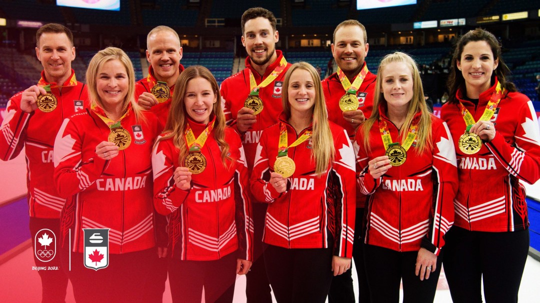Team Canada's curling team for Beijing 2022 pose with their medals