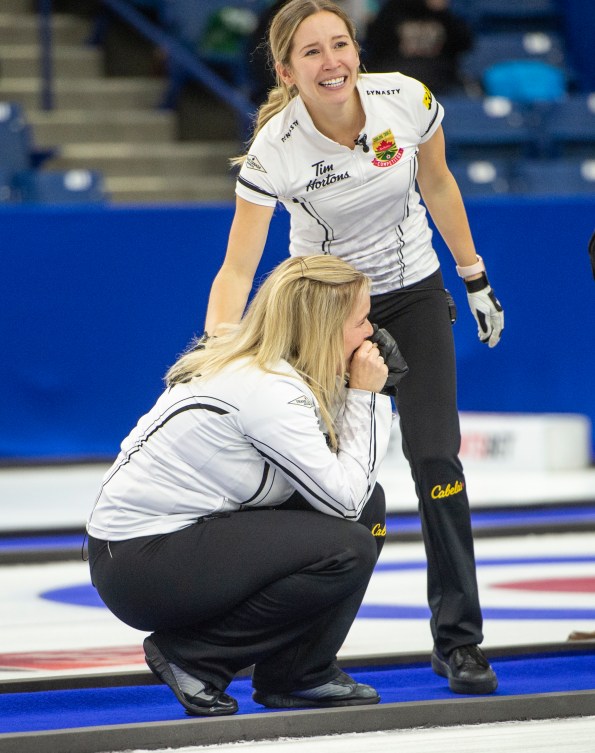 Kaitlyn Lawes puts a hand on Jennifer Jones shoulder as she cries after winning the Canadian curling trials