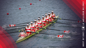 Canada's women's eight row in synchronization in a lake.