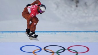 Audrey McManiman jumps over the Olympic rings on an SBX course