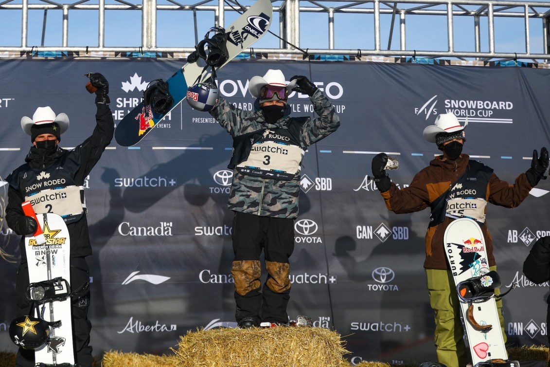 Norway’s Mons Roisland, left, Canada’s Sebastien Toutant (centre) and Luke Winkelmann of the United States celebrate on the podium after the men's World Cup slopestyle snowboard event in Calgary, Alta., Saturday, Jan. 1, 2022. THE CANADIAN PRESS/Evan Buhler
