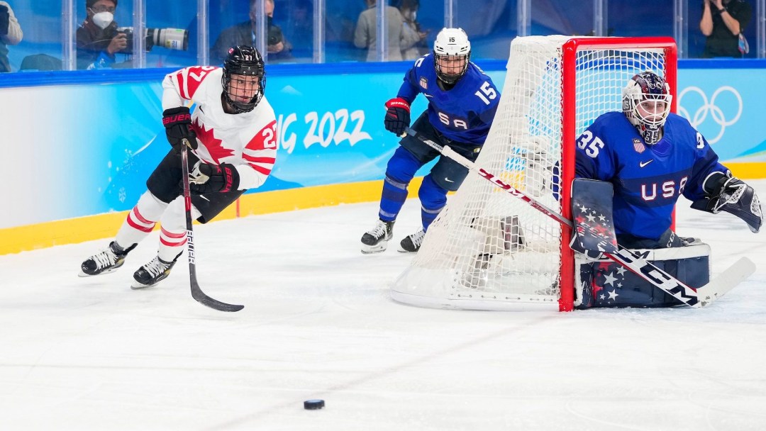 Emma Maltais chases the puck from out behind the American net