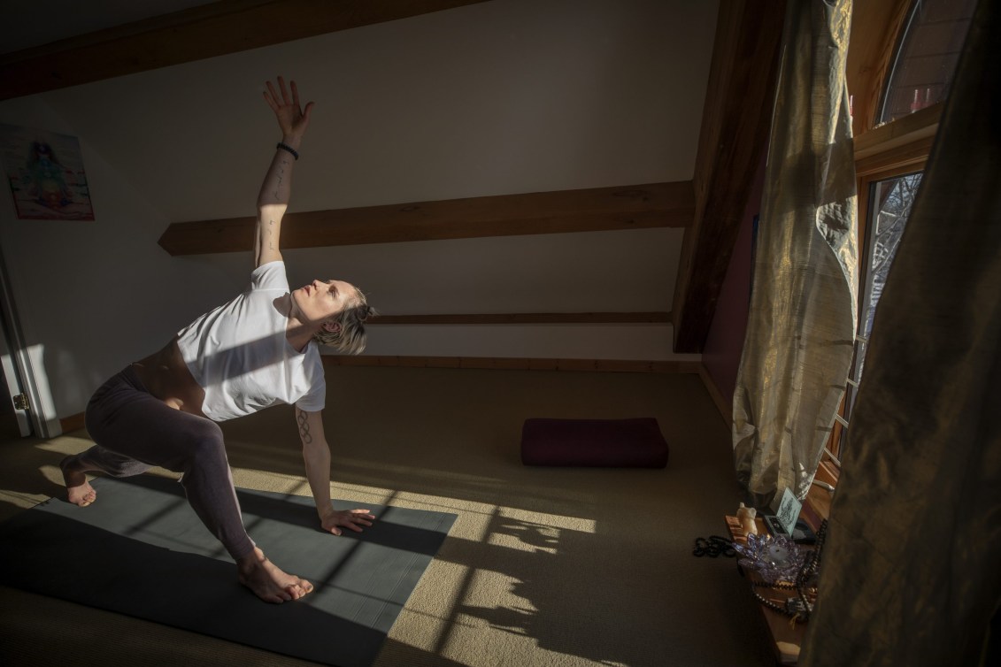 Georgia Simmerling does yoga in front of a window