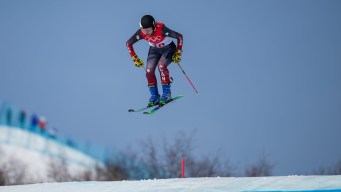 Hannah Schmidt goes over a jump on a ski cross course