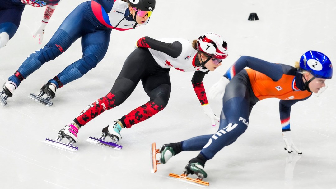 Danae Blais in white and black suit skates in a short track race
