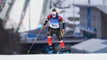 Megan Bankes skis uphill during a biathlon race