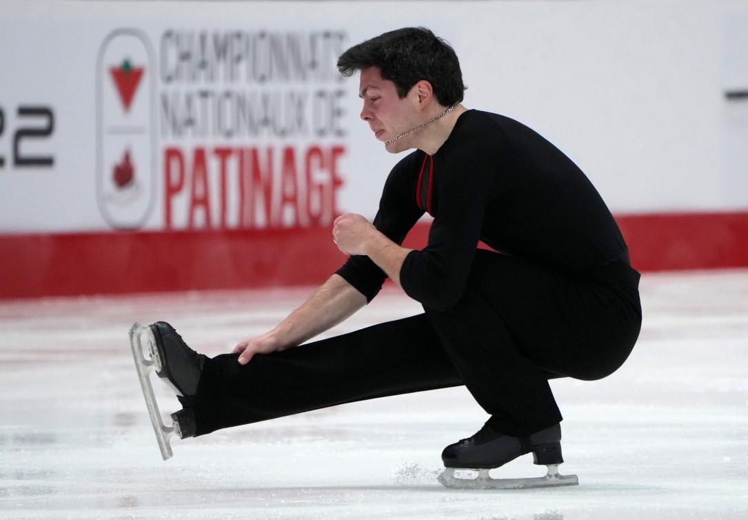 Keegan Messing performs a sit spin 