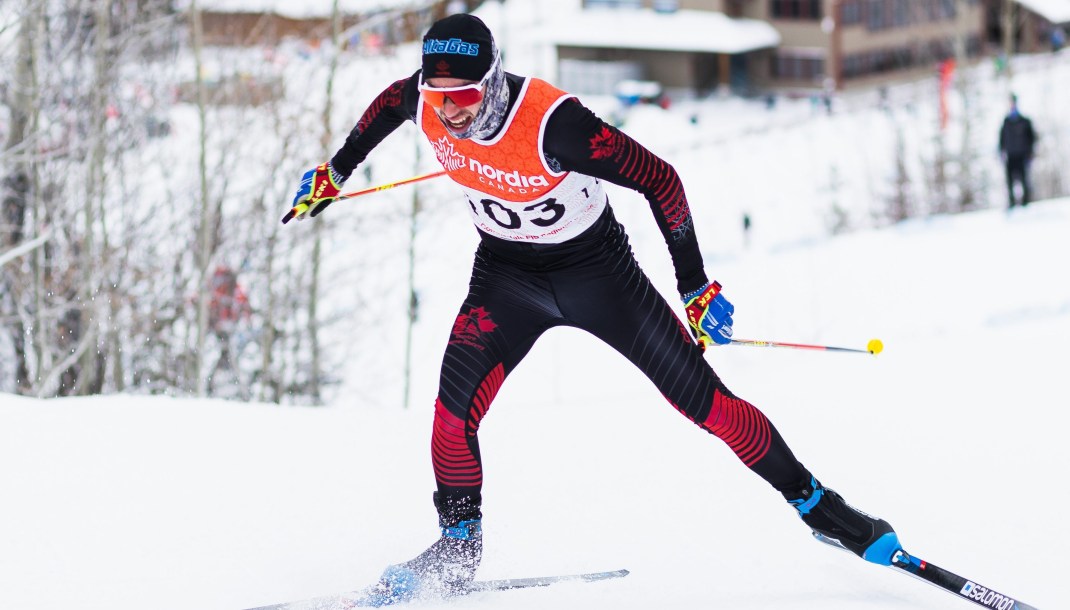 Male athlete is skiing during a cross country race.