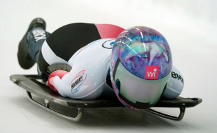 Skeleton athlete sliding down the track.
