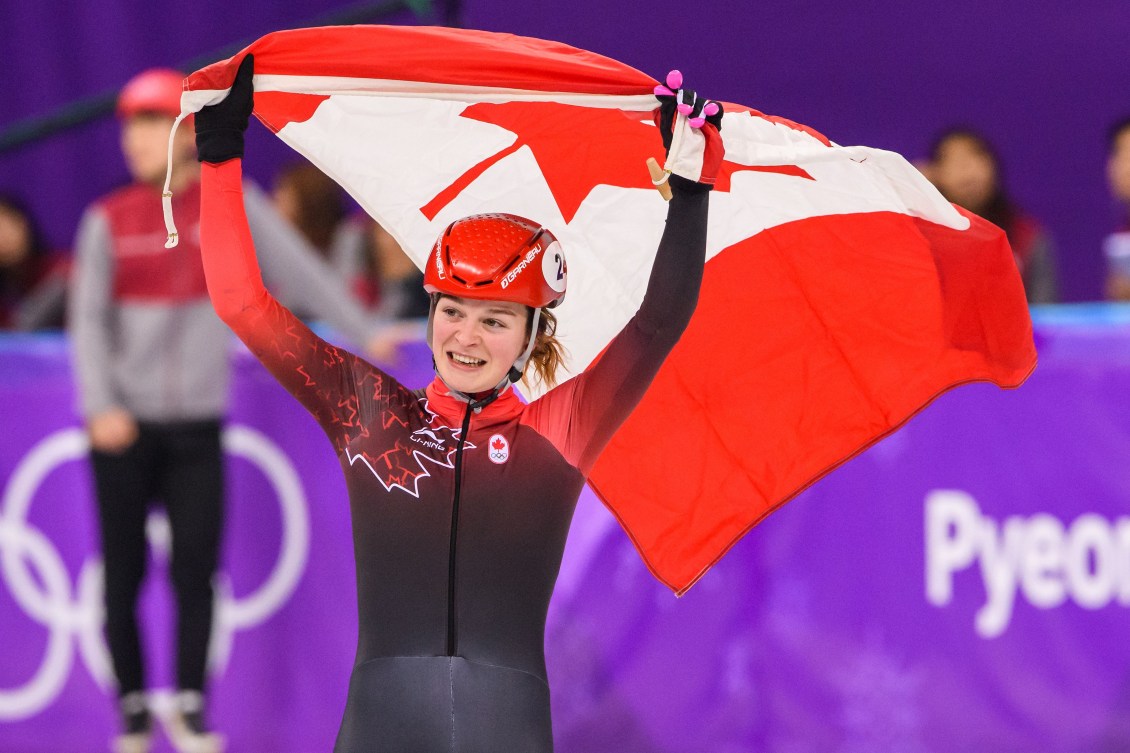 Kim Boutin holds up a Canadian flag as she finishes 2nd in at the Short Track Speed Skating -Women's 1000m Final  at the PyeongChang 2018 Winter Olympic Games at Gangneung Ice Arena on February 22, 2018 in Pyeongchang-gun, South Korea 