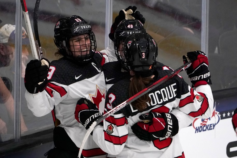 Three women hockey player celebrating after a goal