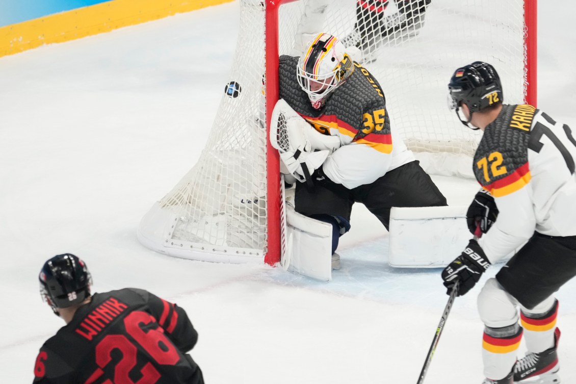 Canada's Daniel Winnik scores past Germany goaltender Mathias Niederberger at Beijing 2022