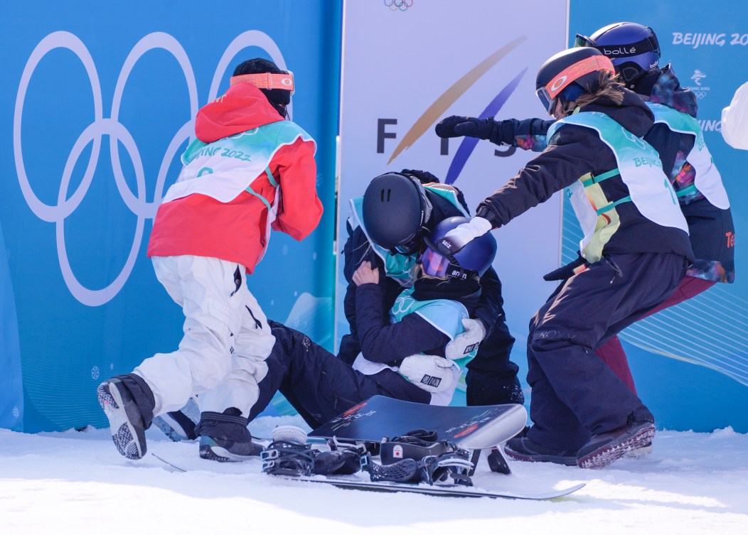 Big air competitors celebrate together at the bottom of the hill