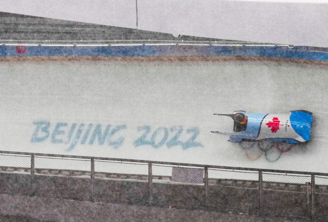 Cynthia Appiah drives her bobsleigh past the Beijing word mark on the track