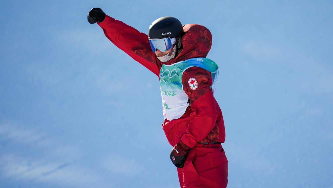 Darcy Sharpe puts his arm in the air in celebration after a run