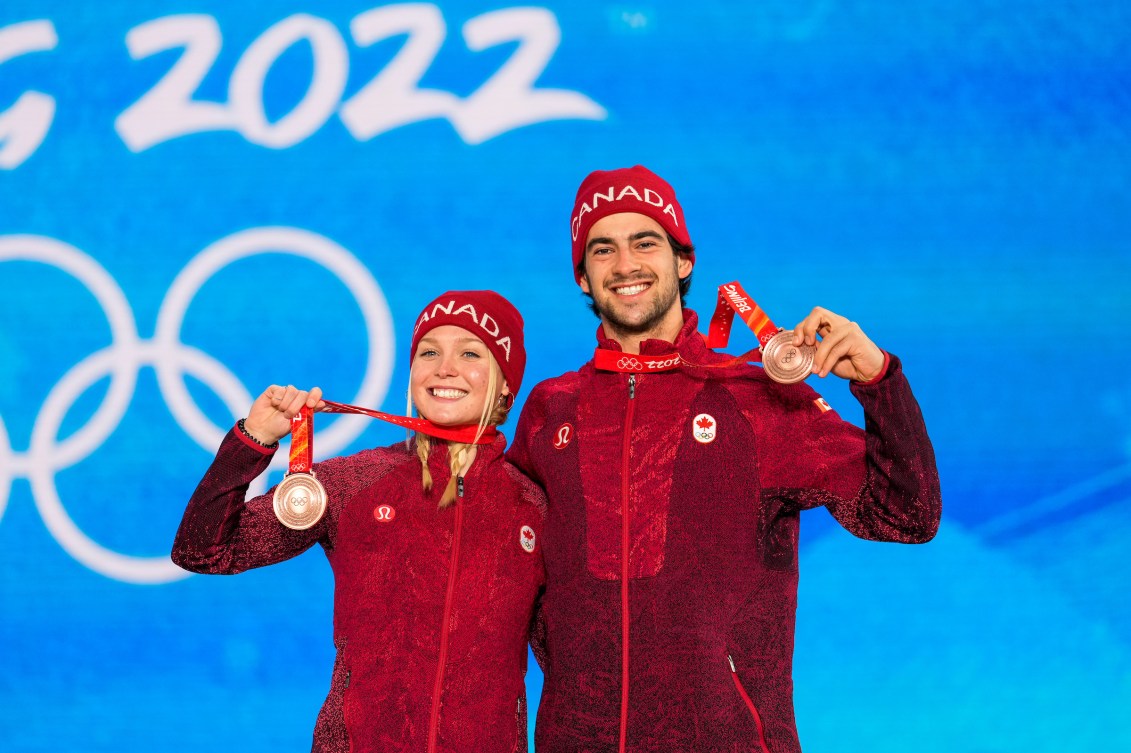 Meryeta O'Dine and Eliot Grondin wear their bronze medals