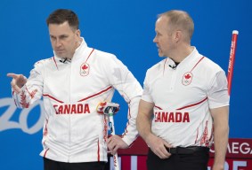 Brad Gushue and Mark Nichols discuss a shot