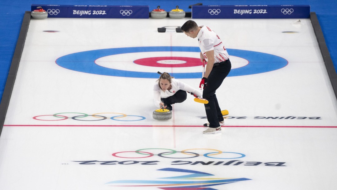 Rachel Homan throws her stone with John Morris ready to sweep