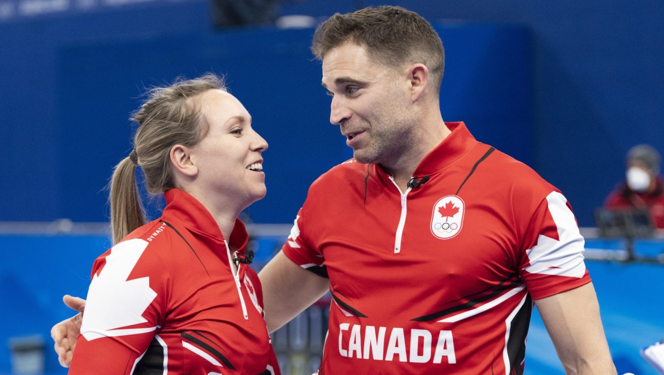 Rachel Homan and John Morris smile after a win