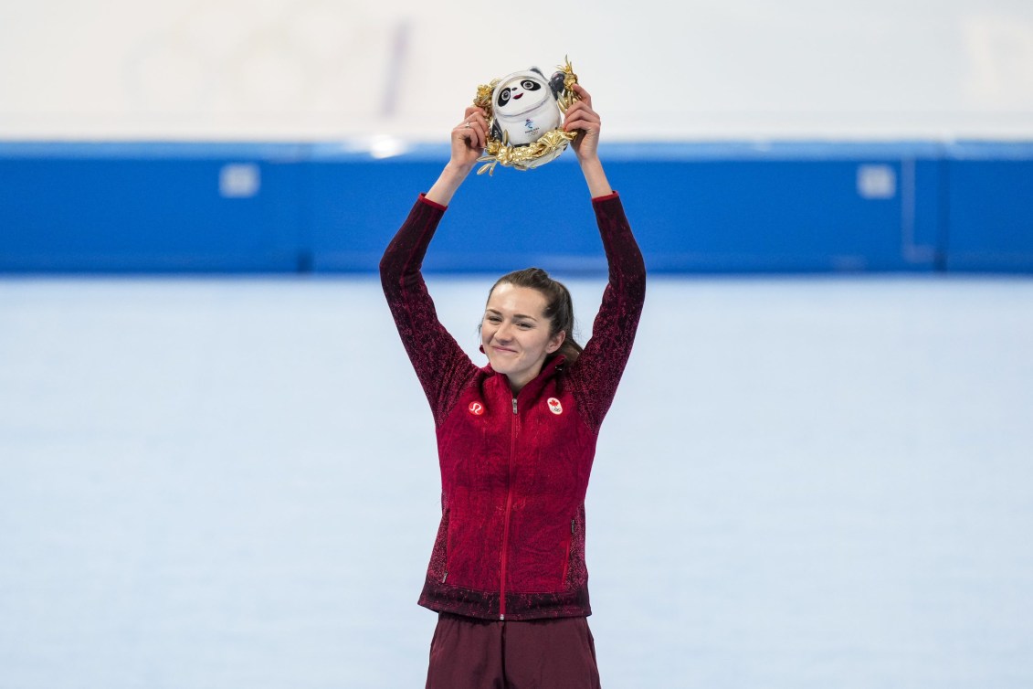 Isabelle Weidemann holds up the Beijing mascot toy on the podium